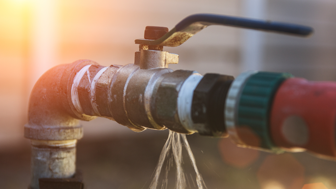 A close up of a faucet with water coming out of it